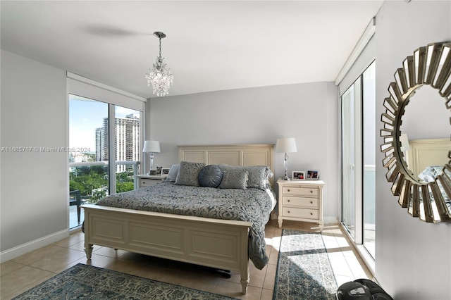 tiled bedroom with access to exterior and an inviting chandelier