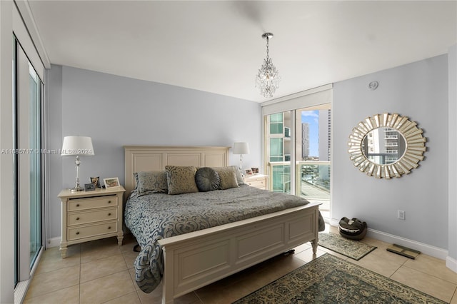 bedroom featuring light tile patterned floors and a notable chandelier