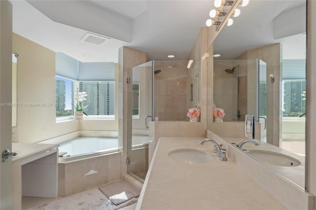 bathroom with vanity and independent shower and bath