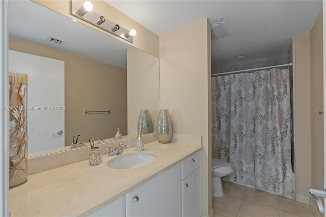 bathroom featuring tile patterned floors, vanity, and toilet