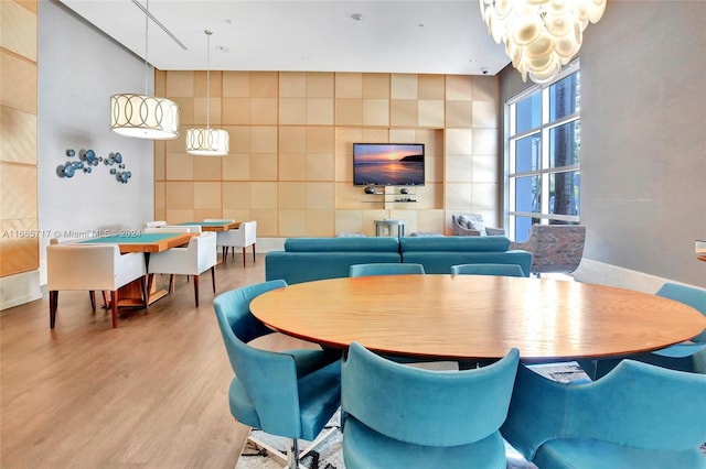 dining area with hardwood / wood-style floors and tile walls