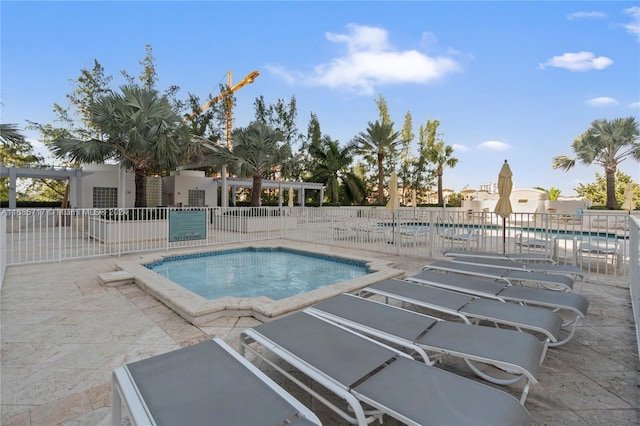 view of pool with a hot tub