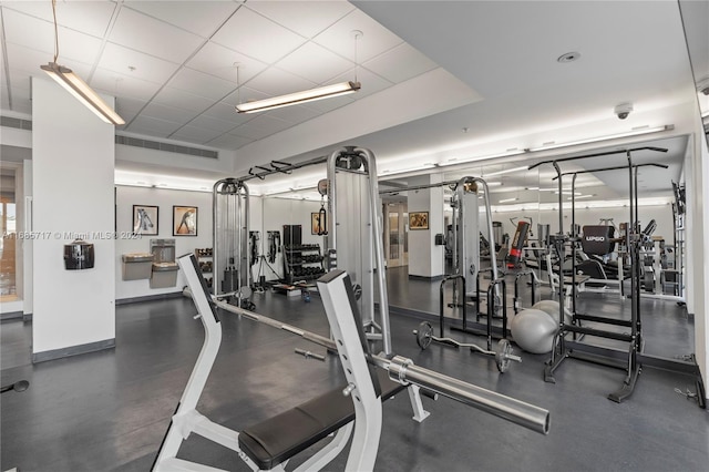 exercise room with a paneled ceiling