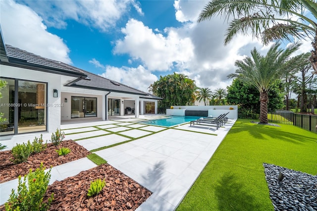 view of swimming pool featuring a patio and a lawn