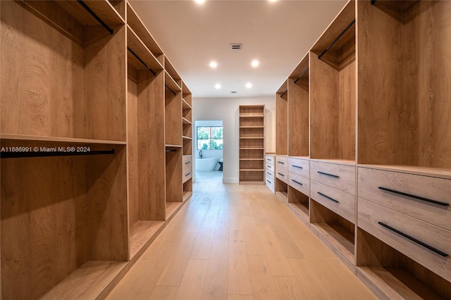 spacious closet featuring light hardwood / wood-style floors