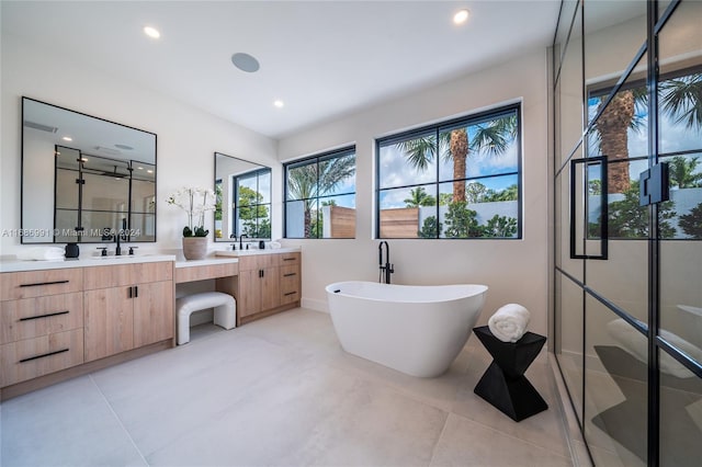 bathroom with vanity and shower with separate bathtub