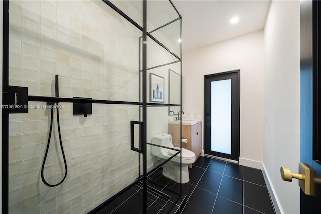 bathroom featuring vanity, toilet, tile patterned flooring, and a shower with door