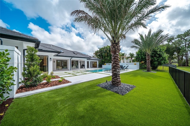 view of yard with a patio and a fenced in pool