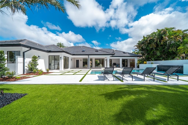 back of house with a patio, outdoor lounge area, and a lawn