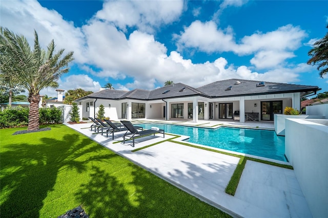 view of swimming pool with a patio area and a lawn