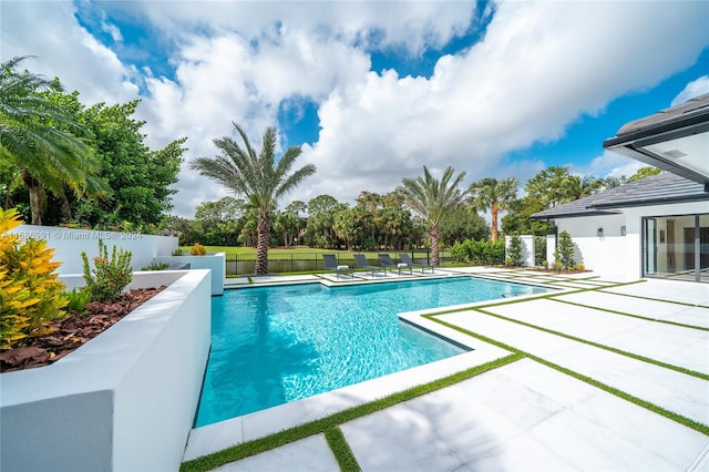 view of swimming pool featuring a patio area