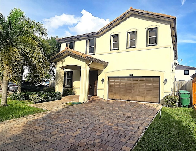 mediterranean / spanish-style home with a garage