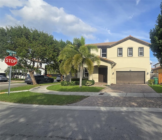 view of front of house with a front yard and a garage