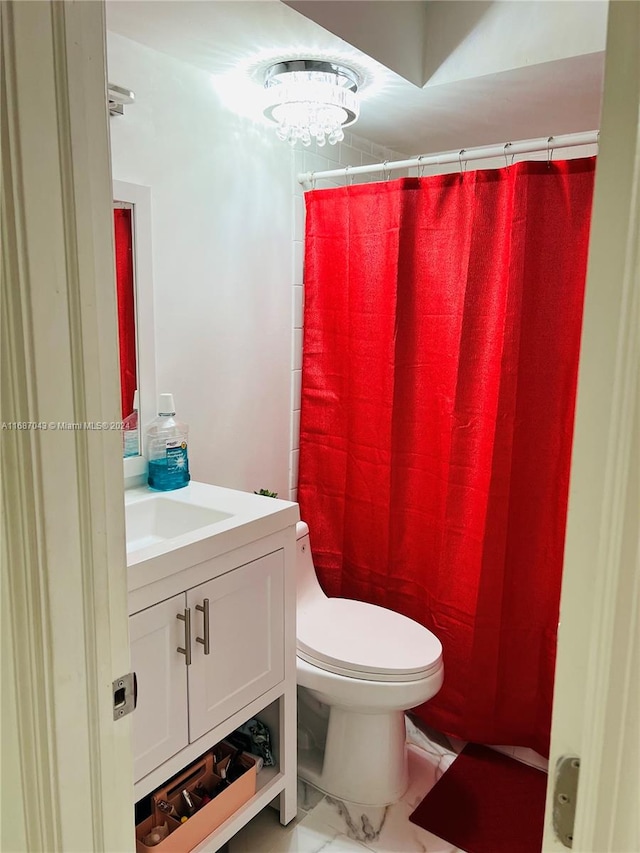 bathroom with vanity, toilet, a chandelier, and curtained shower