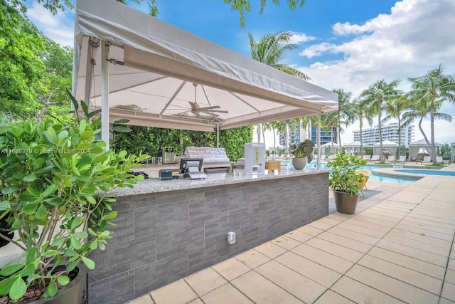 view of patio featuring area for grilling and ceiling fan