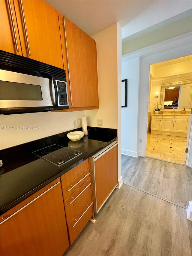 kitchen with light hardwood / wood-style floors and electric cooktop