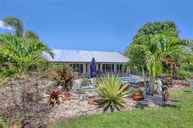 4706 SE Manatee Ter, Stuart, FL 34997 - back of property featuring metal roof, fence, and a patio