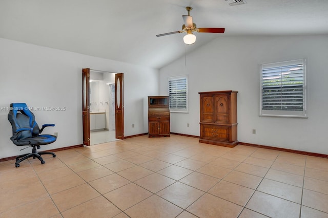 unfurnished bedroom with vaulted ceiling, ceiling fan, light tile patterned floors, and ensuite bath