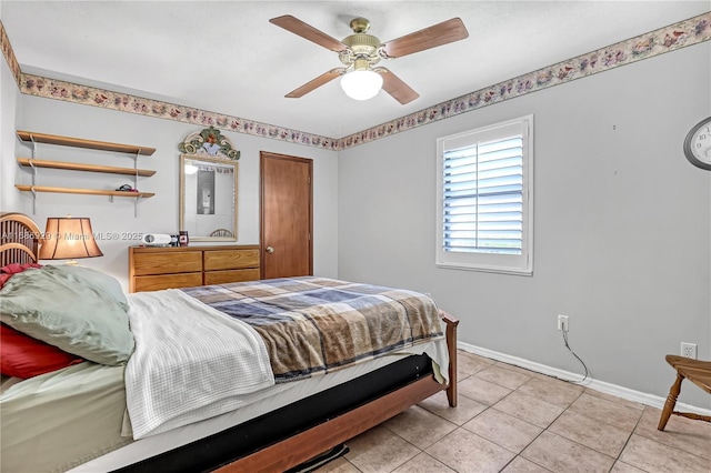 4706 SE Manatee Ter, Stuart, FL 34997 - bedroom with baseboards, light tile patterned floors, and ceiling fan