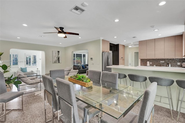 dining room with visible vents, crown molding, and recessed lighting