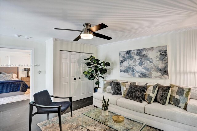 living room featuring crown molding and ceiling fan