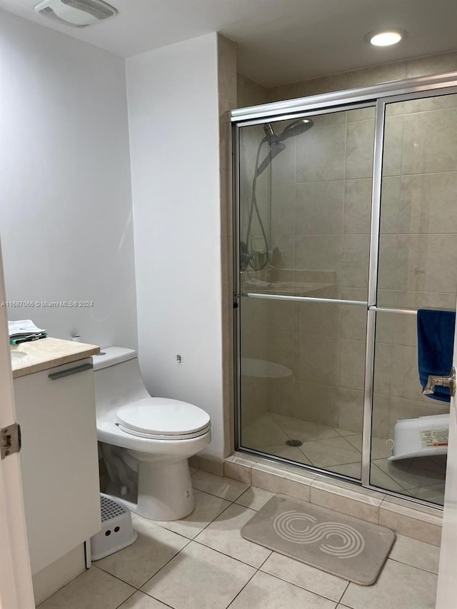 bathroom with toilet, an enclosed shower, vanity, and tile patterned flooring