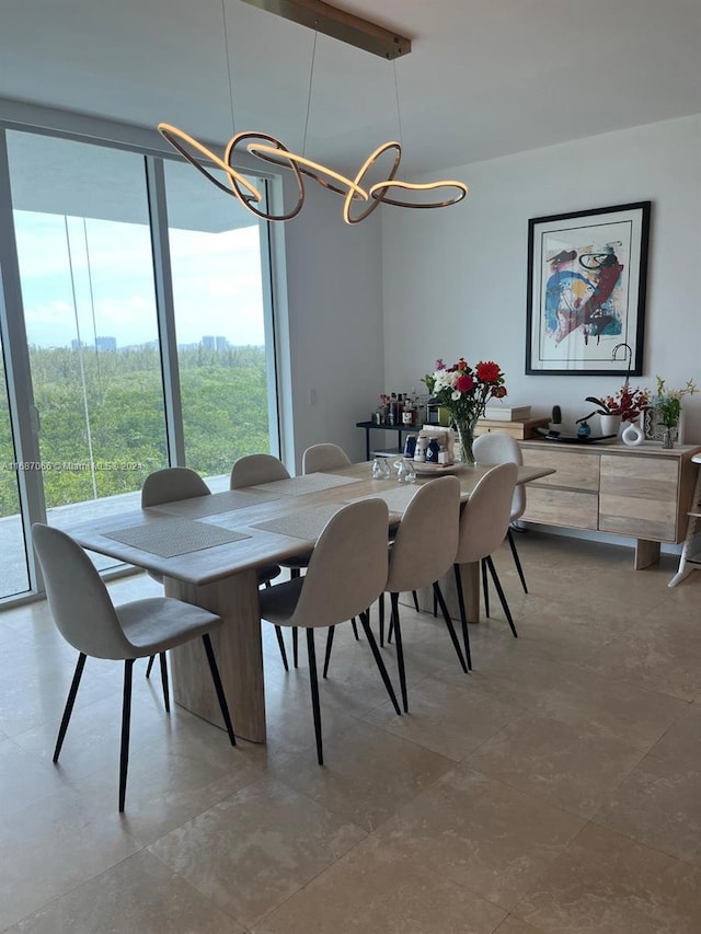 dining space with beamed ceiling and an inviting chandelier