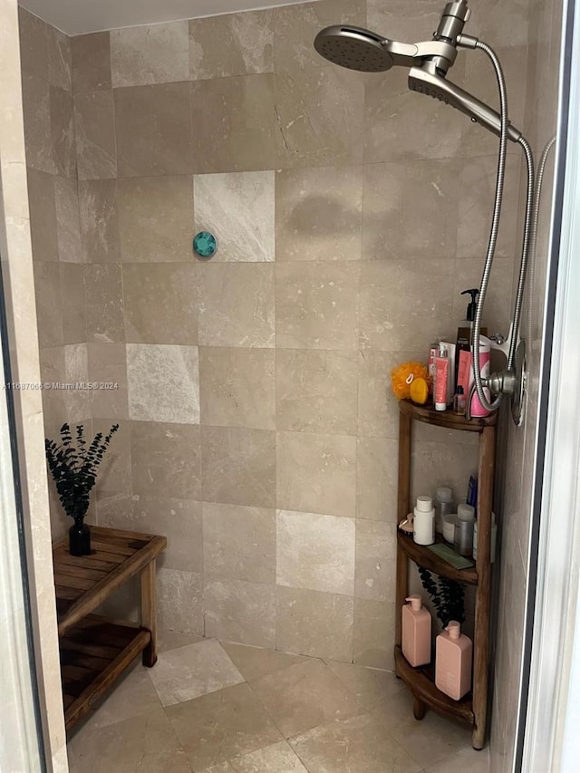 bathroom with a tile shower and tile walls