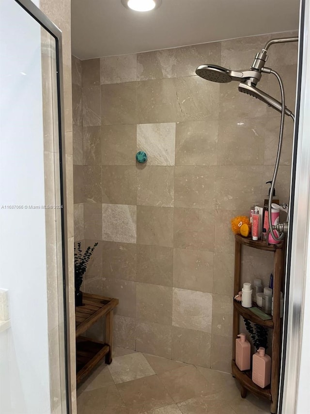 bathroom with tile walls and tiled shower