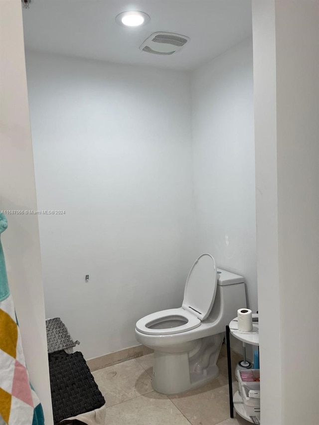 bathroom featuring toilet and tile patterned flooring