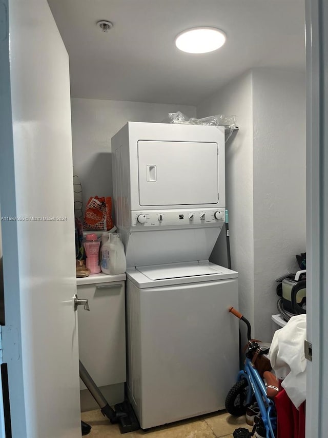 laundry room featuring stacked washer and clothes dryer