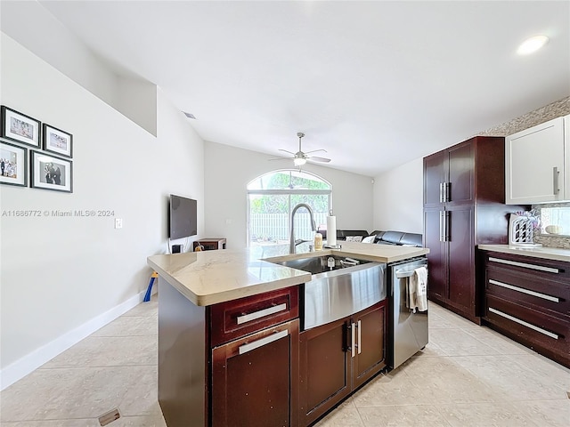 kitchen with a center island with sink, light tile patterned floors, ceiling fan, stainless steel dishwasher, and sink