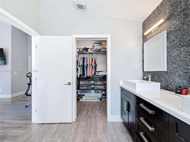 bathroom with vanity, wood-type flooring, and lofted ceiling