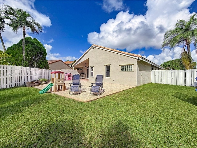 back of house with a yard and a patio area