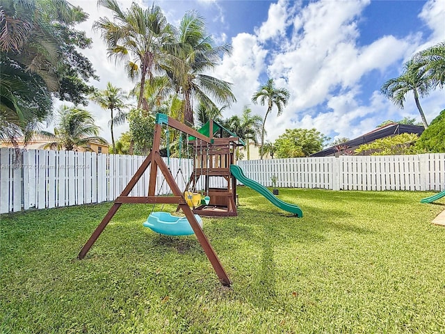 view of jungle gym featuring a lawn