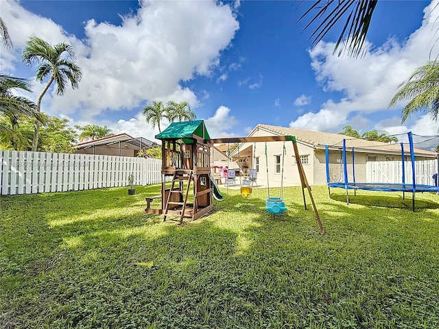 view of play area featuring a yard and a trampoline