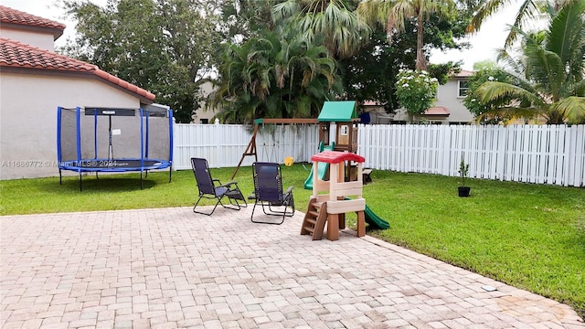 exterior space featuring a playground and a trampoline