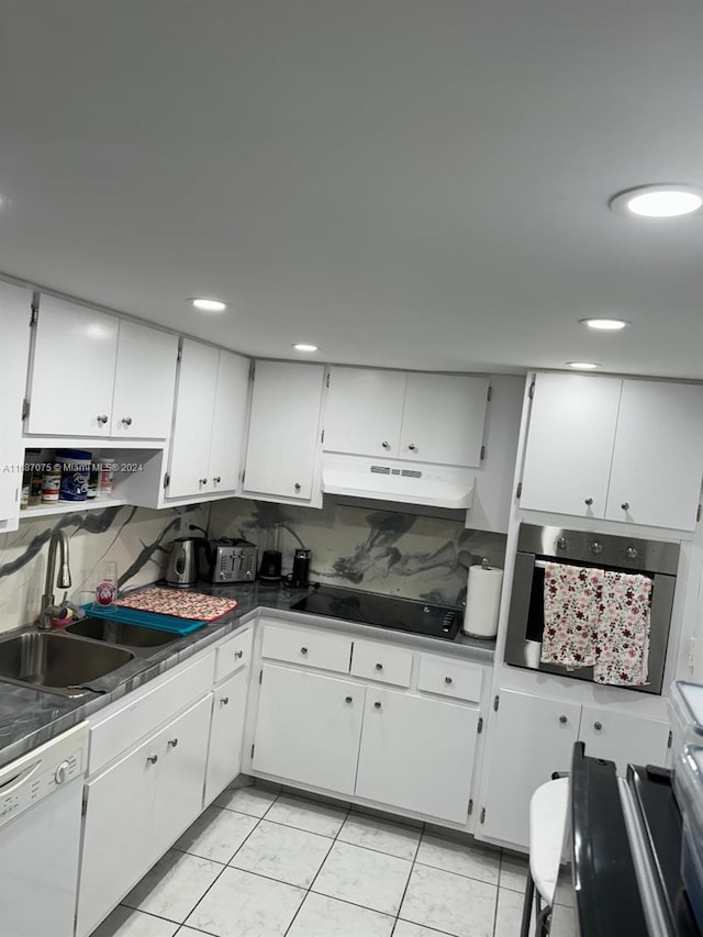kitchen featuring under cabinet range hood, stainless steel oven, white dishwasher, a sink, and black electric cooktop