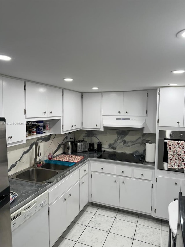 kitchen featuring sink, appliances with stainless steel finishes, white cabinetry, and tasteful backsplash