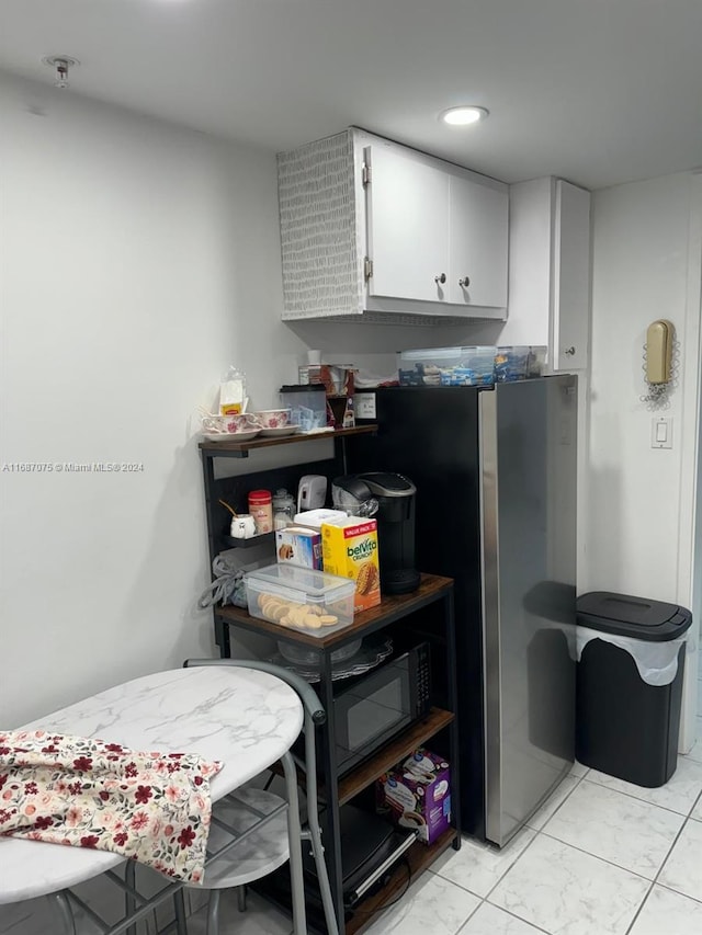 kitchen with white cabinets and stainless steel fridge with ice dispenser