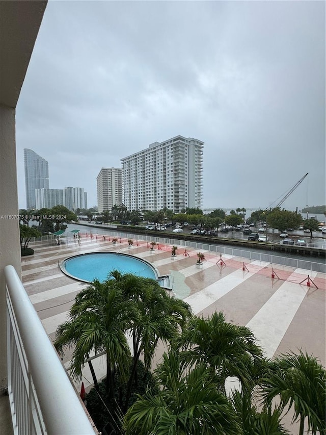 view of swimming pool with a view of city