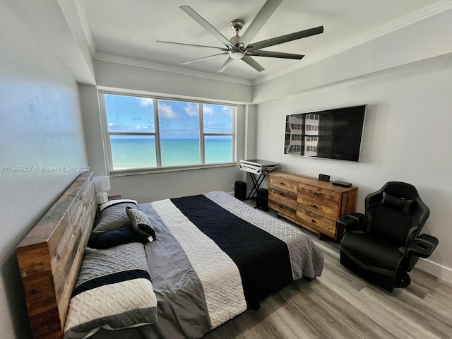 bedroom featuring crown molding, hardwood / wood-style flooring, and ceiling fan