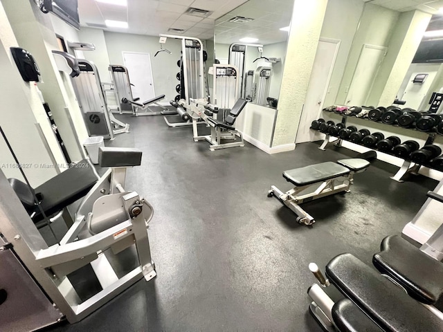 exercise room with a paneled ceiling