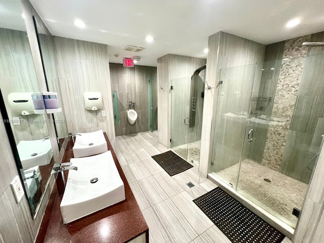 bathroom featuring tile walls, vanity, and an enclosed shower