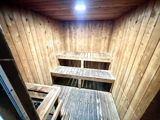 view of sauna with wood walls and wooden ceiling