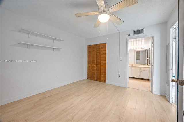 210 174th St Unit 1906, Sunny Isles Beach, FL 33160 - unfurnished bedroom featuring light wood-style flooring, a closet, baseboards, ceiling fan, and ensuite bath