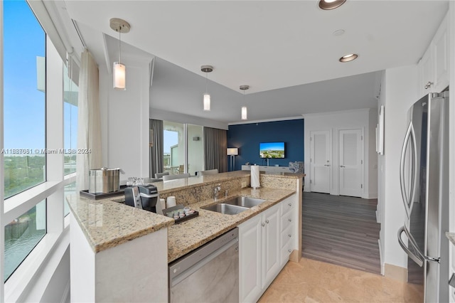4401 Collins Ave Unit 1214, Miami Beach, FL 33140 - kitchen featuring stainless steel appliances, white cabinets, healthy amount of natural light, light stone countertops, and recessed lighting