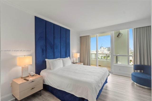 bedroom featuring light wood-type flooring and crown molding