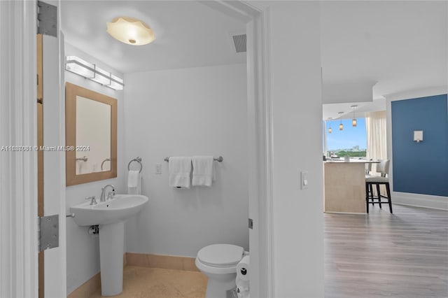 bathroom featuring sink, toilet, and hardwood / wood-style flooring