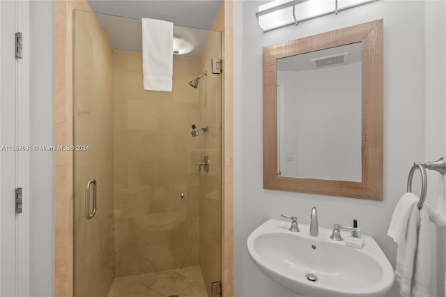 bathroom featuring sink and an enclosed shower